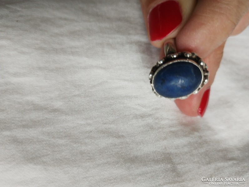 A huge silver ring with lapis lazuli stones in an ornate setting