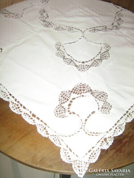A white filigree tablecloth with a dreamy lace edge sewn insert is a specialty