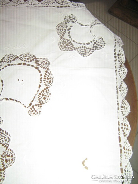 A white filigree tablecloth with a dreamy lace edge sewn insert is a specialty