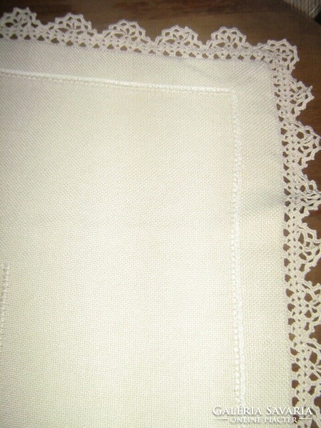 A woven tablecloth embroidered with beautiful crocheted edges