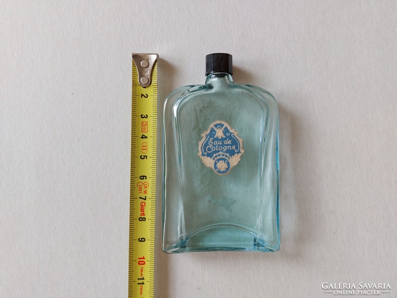 Old perfume bottle with blue cologne bottle label