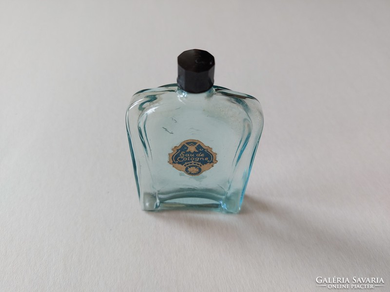 Old perfume bottle with blue cologne bottle label