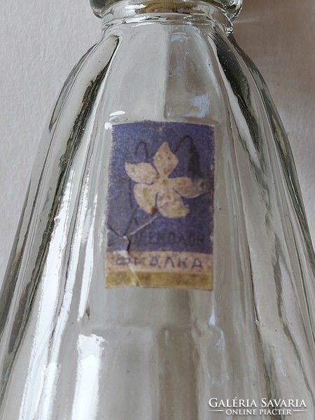 Old perfume glass cologne bottle with retro label
