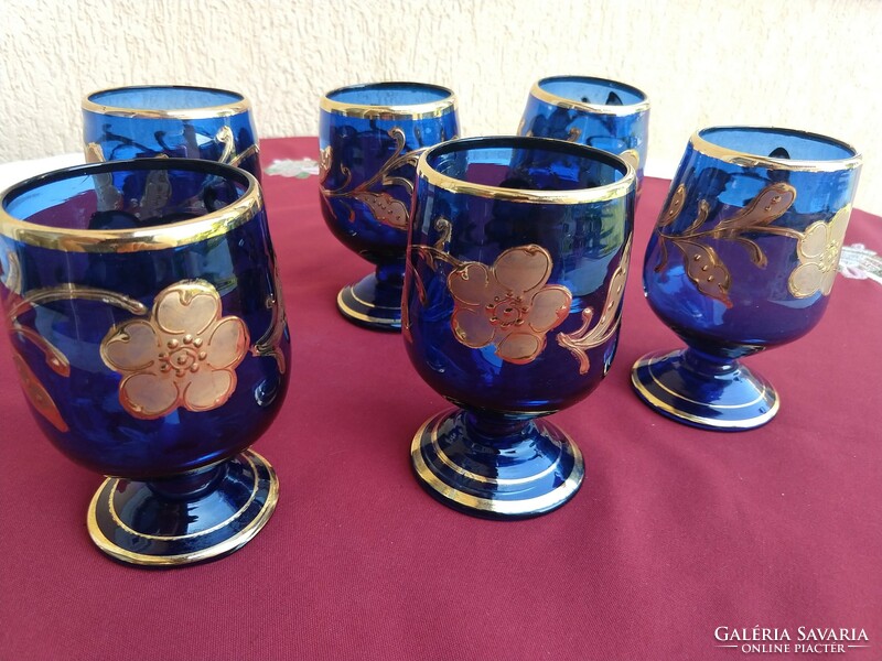 A set of six blue, richly gilded, stemmed glasses with a broken bottom, 12 cm high,,