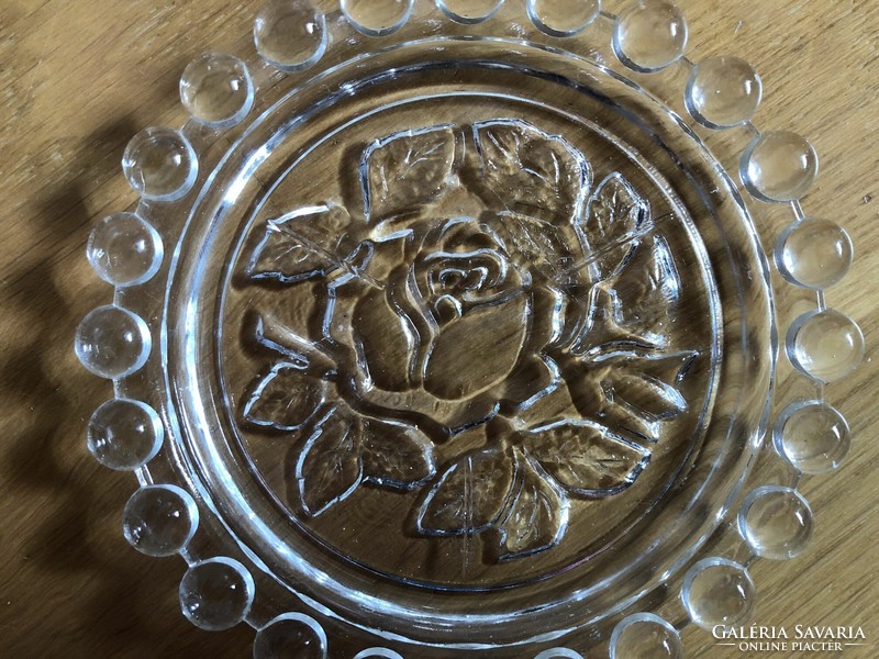 Rose flower in small glass plate, ashtray?