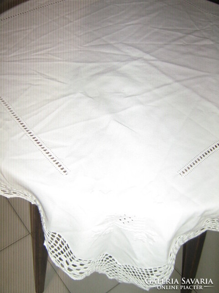 Beautiful azure hand-embroidered white filigree tablecloth with a crocheted edge