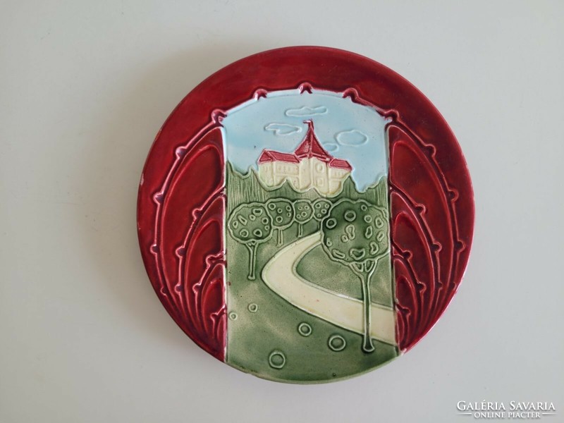 Old majolica wall plate with castle pattern, faience wall decoration