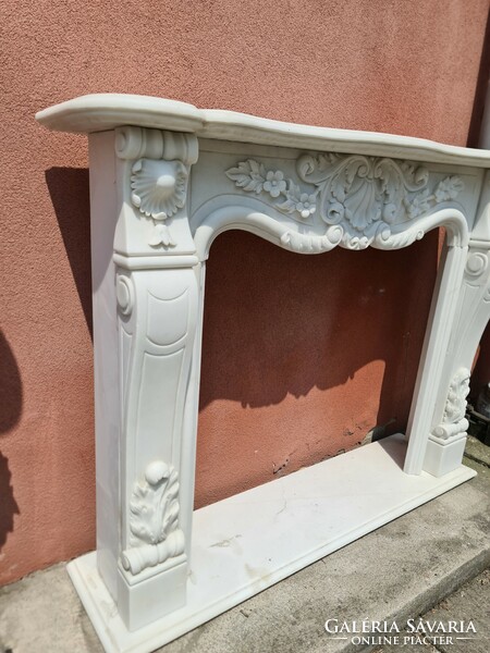 White marble fireplace with floral decoration