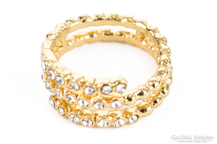 A spiral ring with many zirconia stones is gold-colored, a special piece of jewelry.