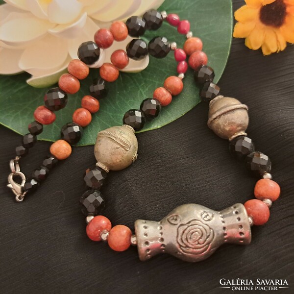 Antique handmade ornaments, coral and crystal necklaces.
