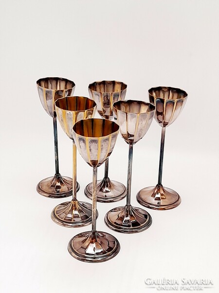 A set of short drinking glasses with a silver-plated base