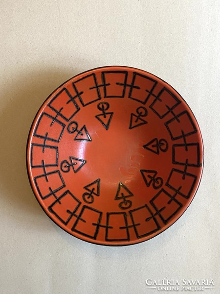 Retro ceramic bowl centerpiece with black geometric painting on an orange base