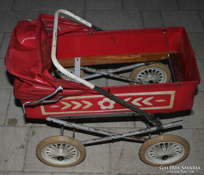 Old retro stroller in red color.