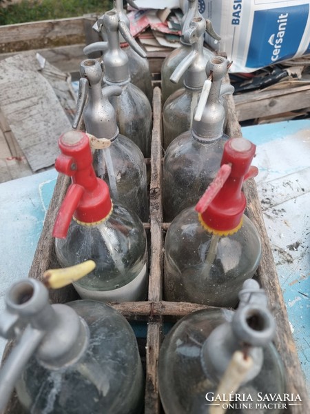 Old soda bottles with a worn case.