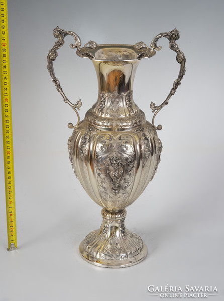 Large silver vase with cream-shaped ears, richly decorated