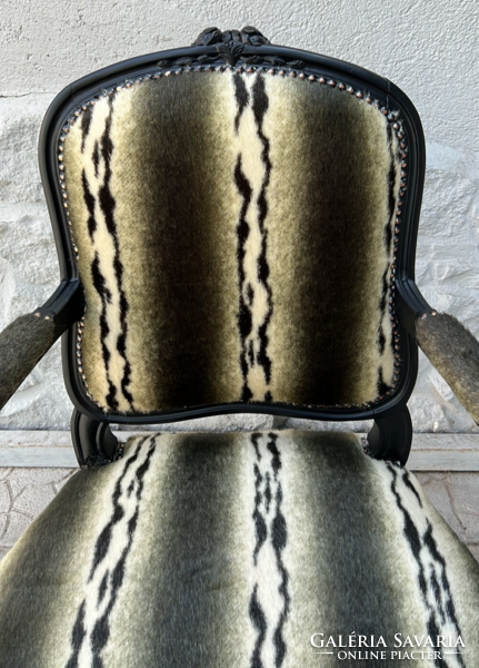 Matt black frame-style armchair with faux fur upholstery