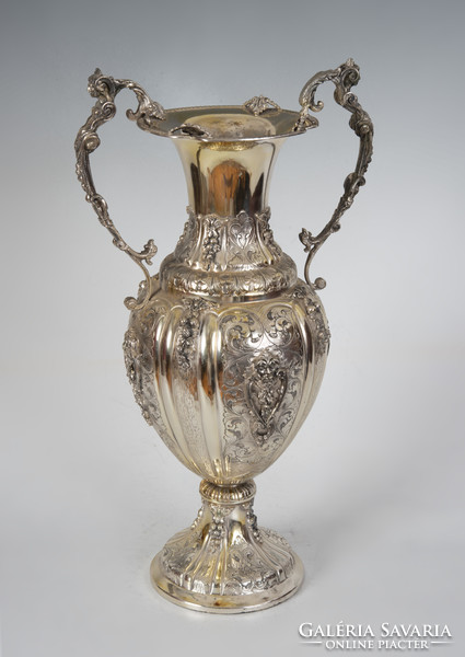 Large silver vase with cream-shaped ears, richly decorated