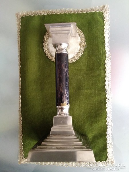 Candle holder in the shape of a Doric column, with a stepped engraved pattern and a silver-plated base.
