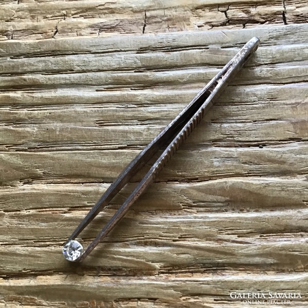 Silver pendant in the shape of an old Hungarian tweezer with a small stone