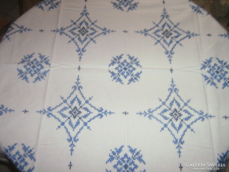 Beautiful tablecloth embroidered with blue cross stitch