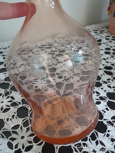 Salmon colored cut glass bottle