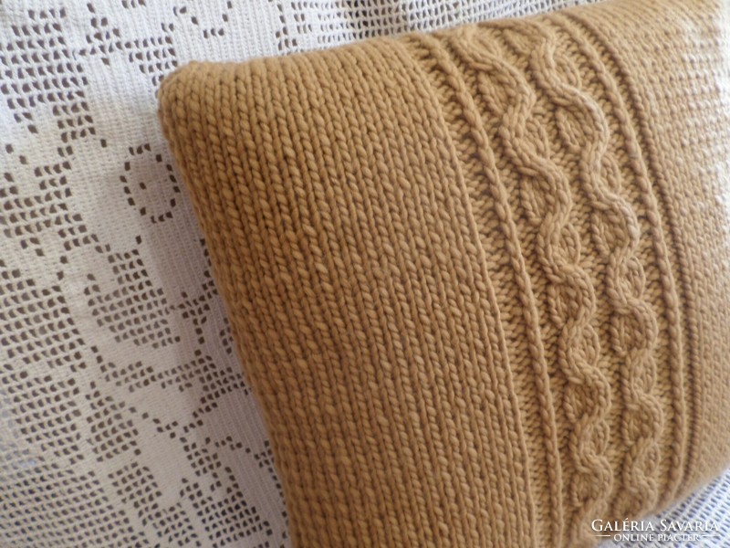 Cappuccino-colored hand-knitted decorative pillow.