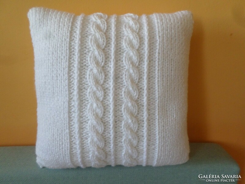 Snow-white hand-knitted decorative pillow.