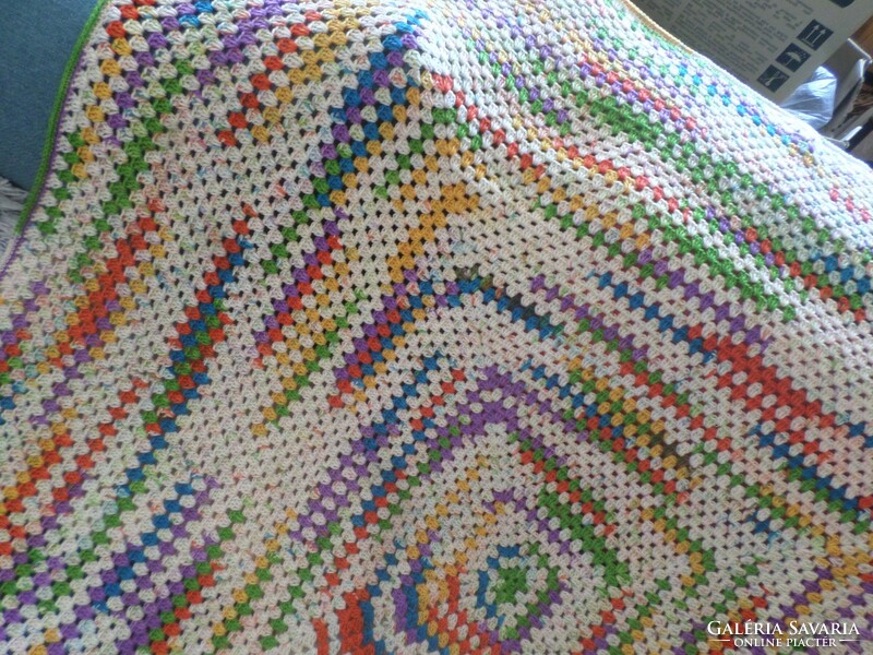 Colorful hand crocheted sofa or armchair cover.