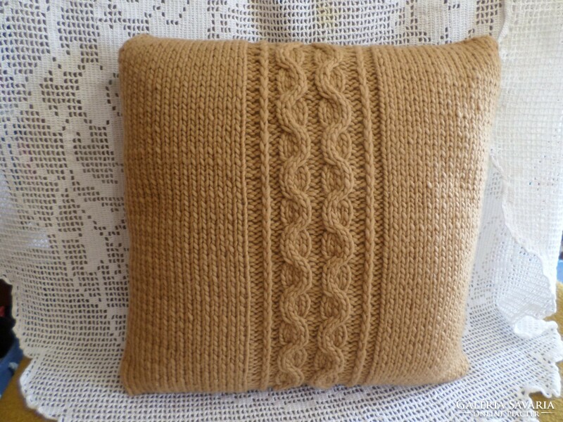 Cappuccino-colored hand-knitted decorative pillow.