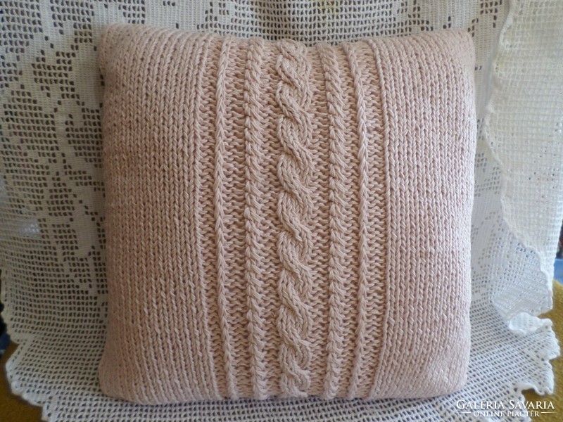 Antique pink hand-knitted throw pillow.