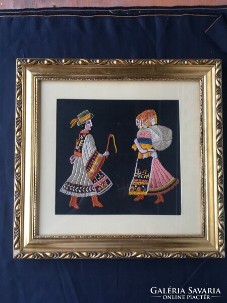 Folk scene embroidered wall picture.