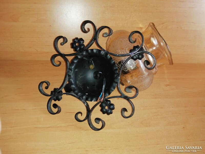 Wrought iron wall lamp with glass shade