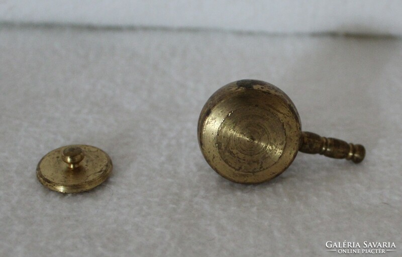 A miniature copper bowl with a handle