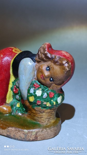 Marked antique ceramic figure of a girl with a bouquet