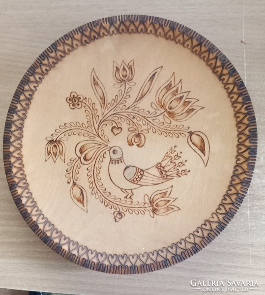Wooden plate (1) pyrographed with folk motifs.