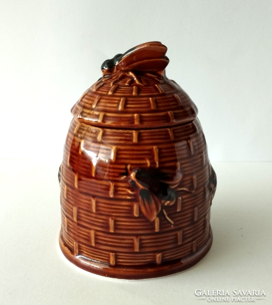 A majolica honey dispenser in the shape of a beehive