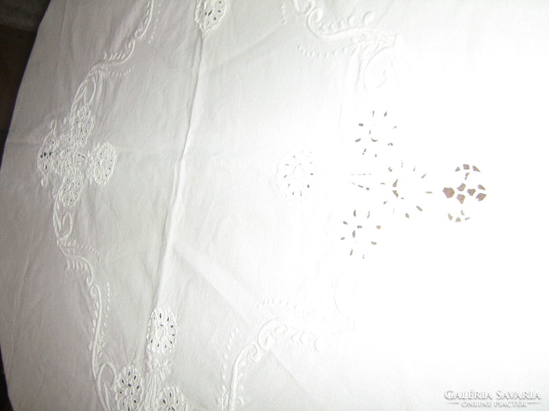Beautiful snow-white sewn embroidered floral tablecloth