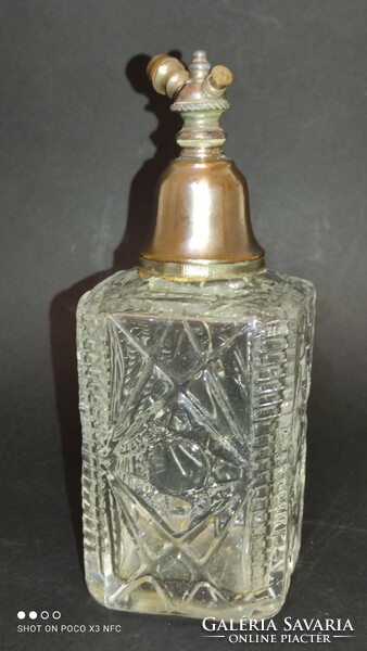 Antique perfume bottle with metal perfume highlighter
