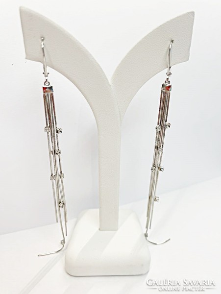 Long, dangling silver earrings with stones