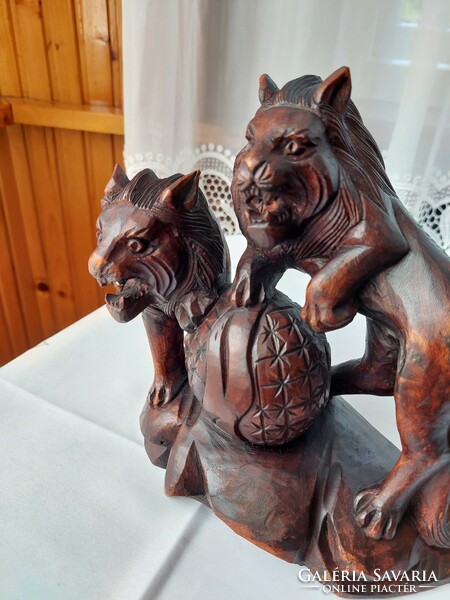 A wooden carved two roaring lions in very good condition.