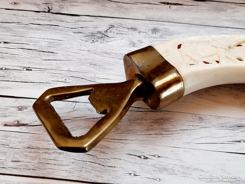 Copper bottle opener with carved bone handle, elephant motifs, 16 cm