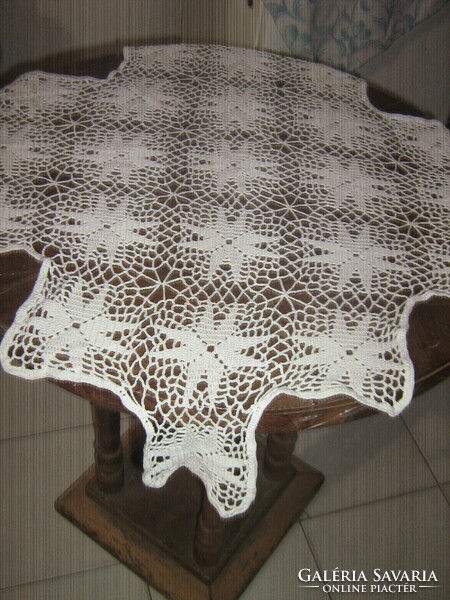 A beautiful, hand-crocheted tablecloth with a special shape