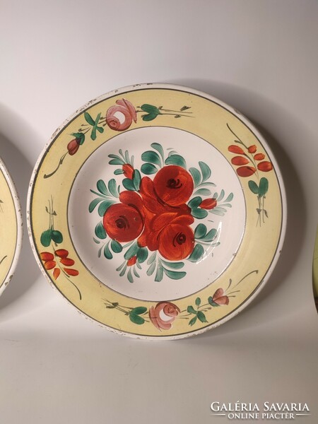 A pair of painted folk wall plates in hard terracotta marked Old Hóllóháza