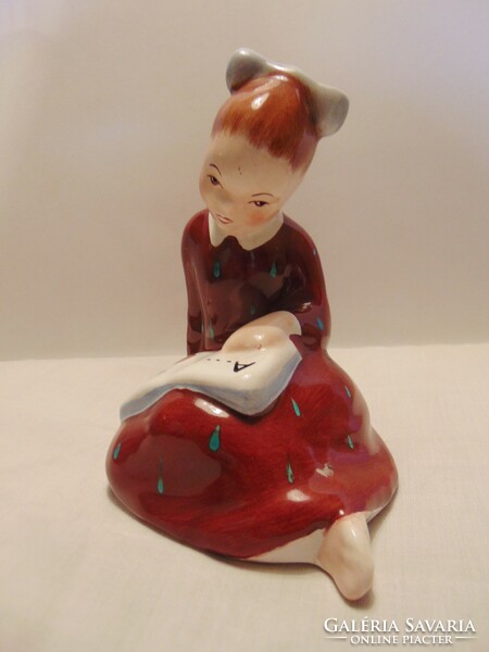 Little girl reading Bodrogkeresztúr ceramics