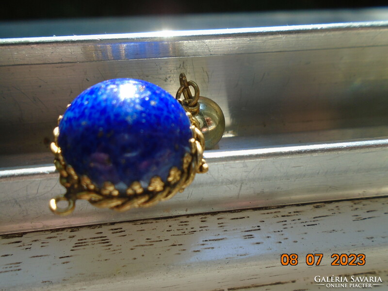 Lapis lazuli hemisphere in a decorative ormolu fire-gilt socket with a gilt sphere