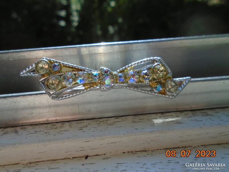Silver-plated filigree bow brooch with polished iridescent stones