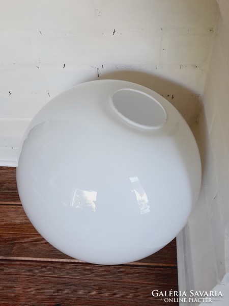 A very large white spherical lampshade without a rim