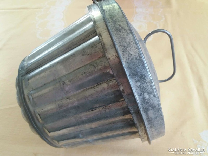 Old metal pudding cooker with a lid