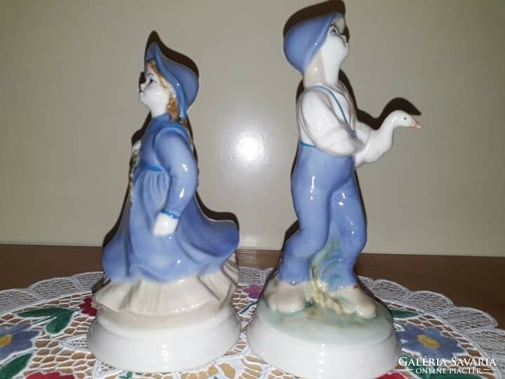 Apulum porcelain figurines in display case, 15.5cm and 17.5cm tall. Together, 7000 plus postage.