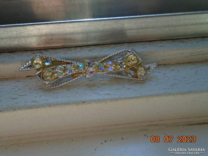 Silver-plated filigree bow brooch with polished iridescent stones